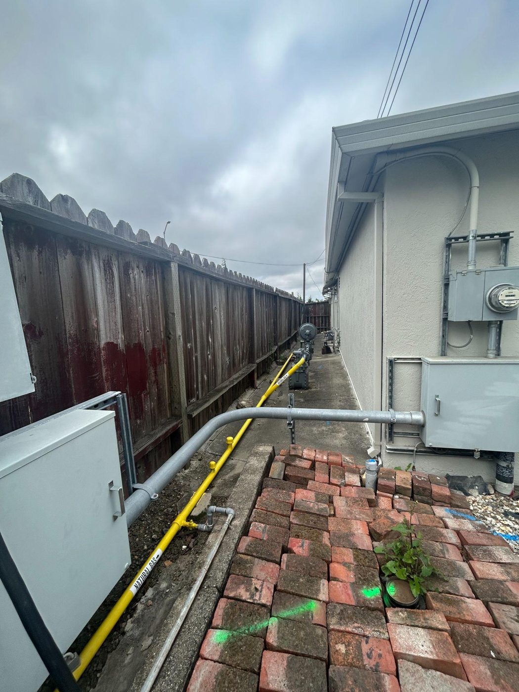 Natural gas pipeline tie-in installed along a residential property line